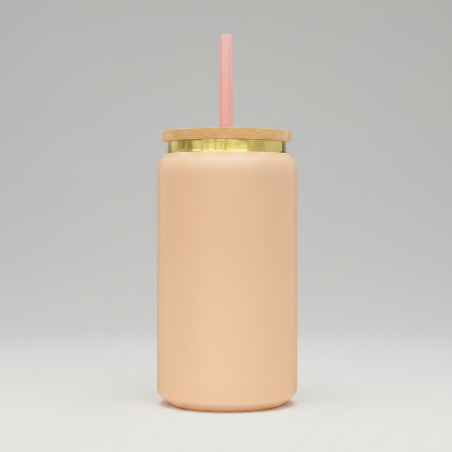 Peach tumbler with a gold rim and pink straw