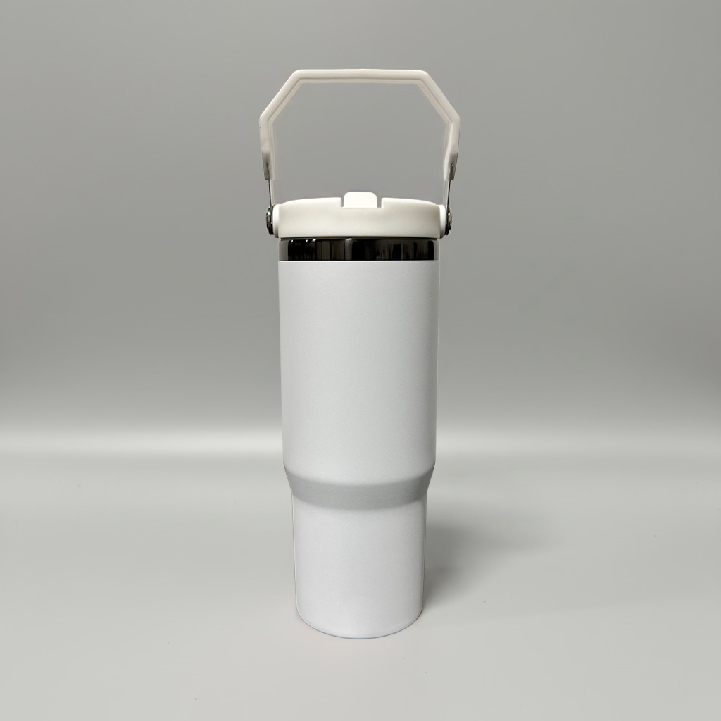 A matte white insulated travel tumbler with a matching white handle lid and a thin metallic silver band near the top, shown on a neutral gray background.