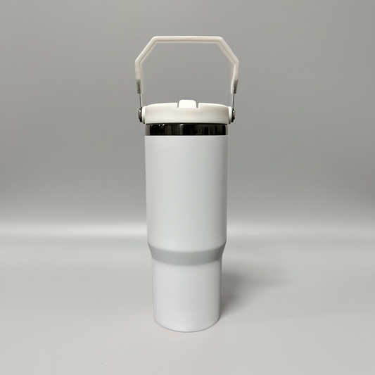 A matte white insulated travel tumbler with a matching white handle lid and a thin metallic silver band near the top, shown on a neutral gray background.