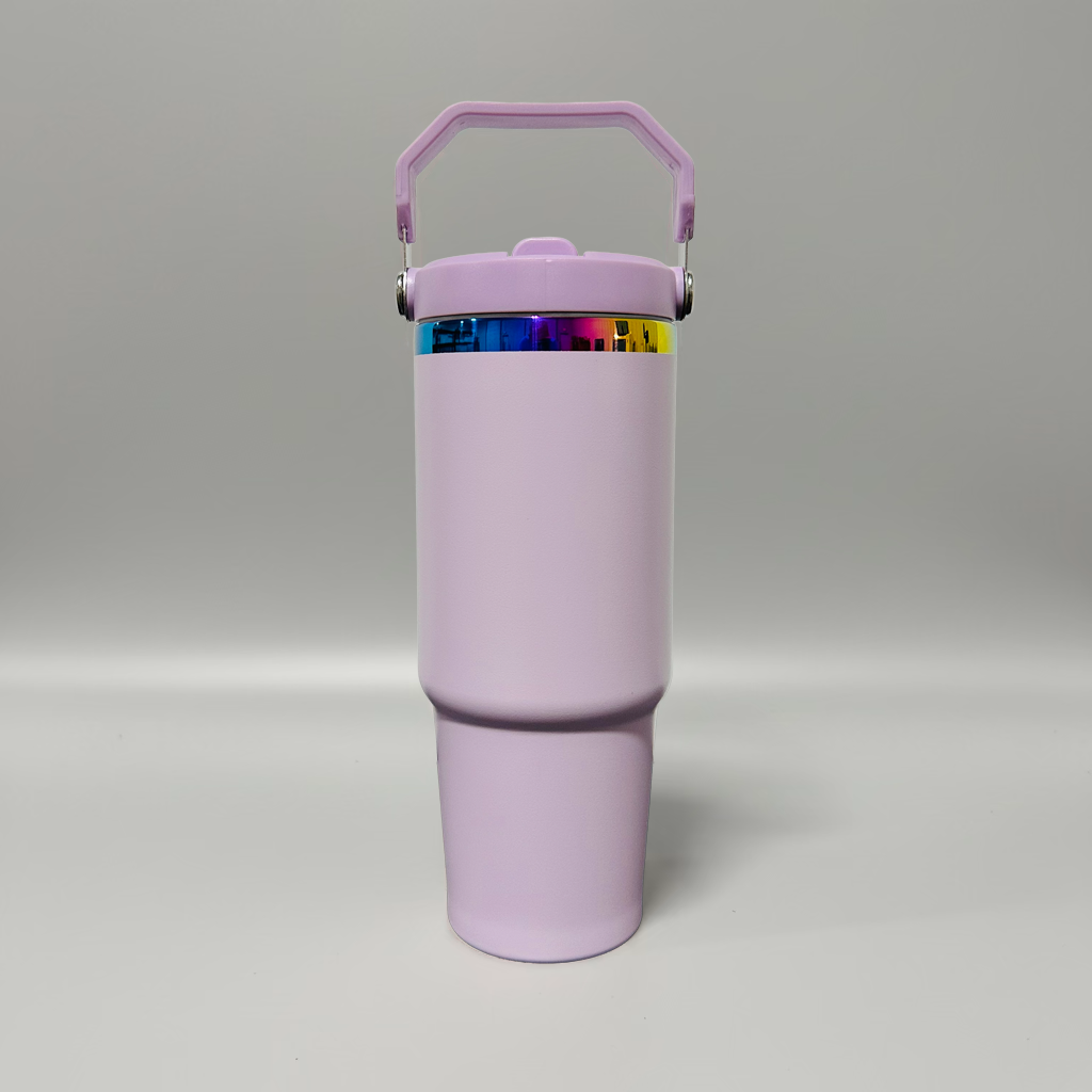 A light purple insulated travel tumbler with a matching handle lid and a colorful metallic band around the neck, shown on a neutral gray background.