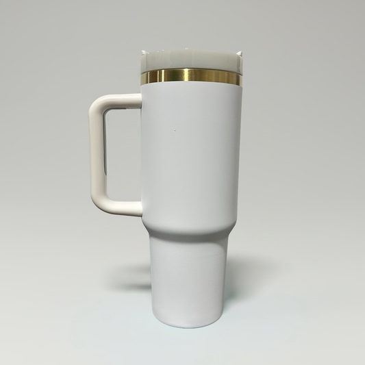 A white ceramic travel mug with a matching handle and lid, featuring a thin gold metallic band around the neck, set against a neutral light gray background.