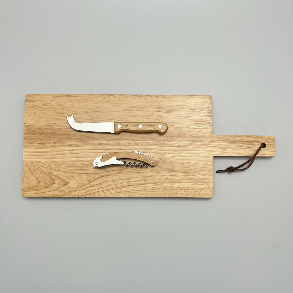 A rectangular wooden serving board with a handle, shown on a dark textured surface. The board includes a small cheese knife with a light wood handle and a corkscrew tool attached or displayed on top.